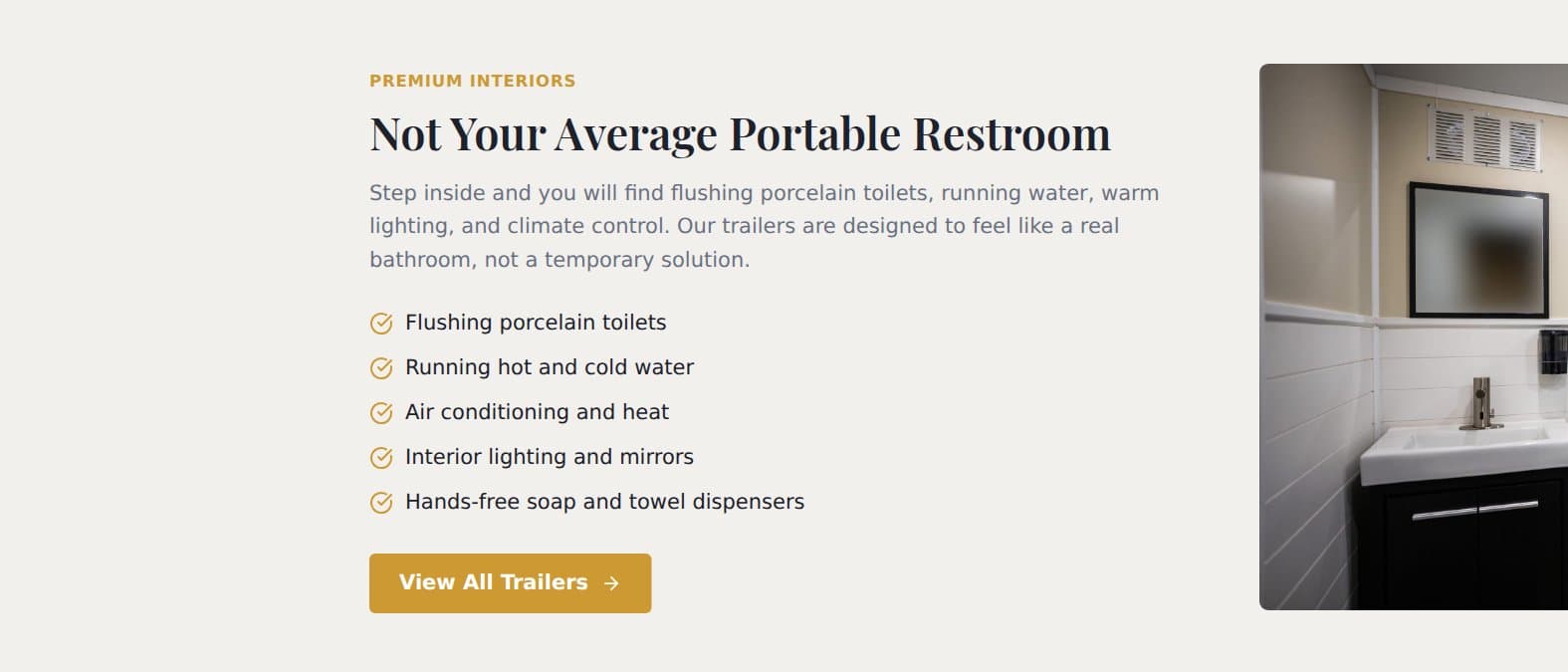 The premium interiors section of the homepage: interior photography beside the amenity list, from flushing porcelain toilets to climate control.